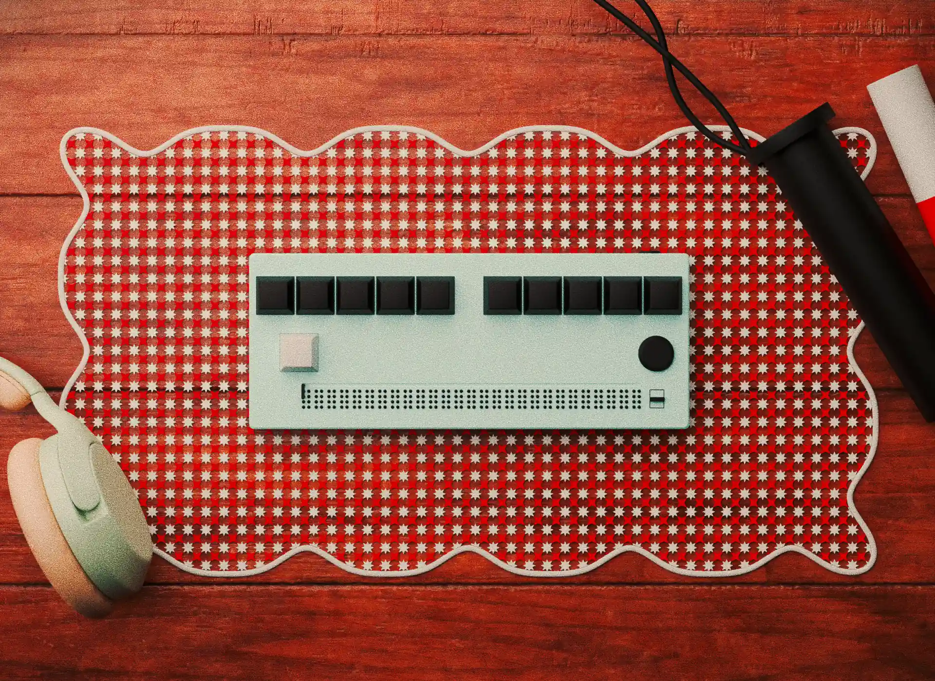 A braille display placed on  wooden table. In the top right is there is a cane and in the bottom left a pair of light green headphones.